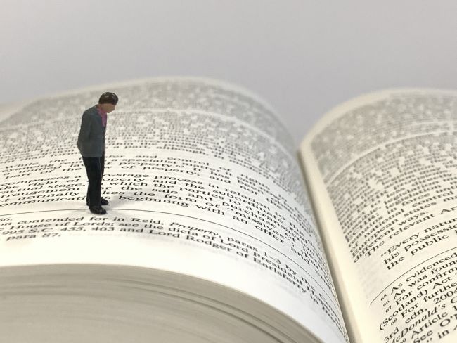 Small model figure standing on a book