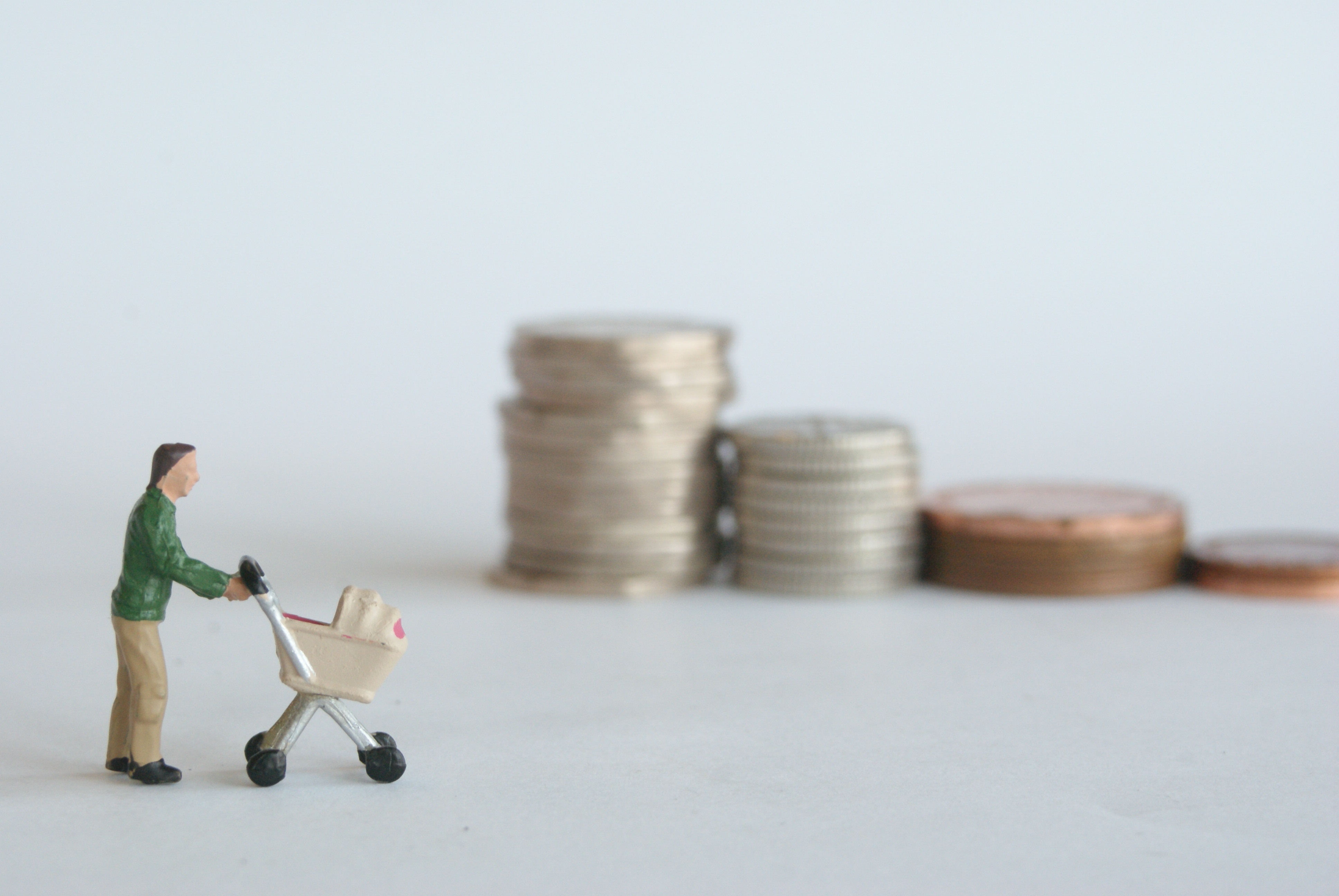 Small model figures standing on metal food tins