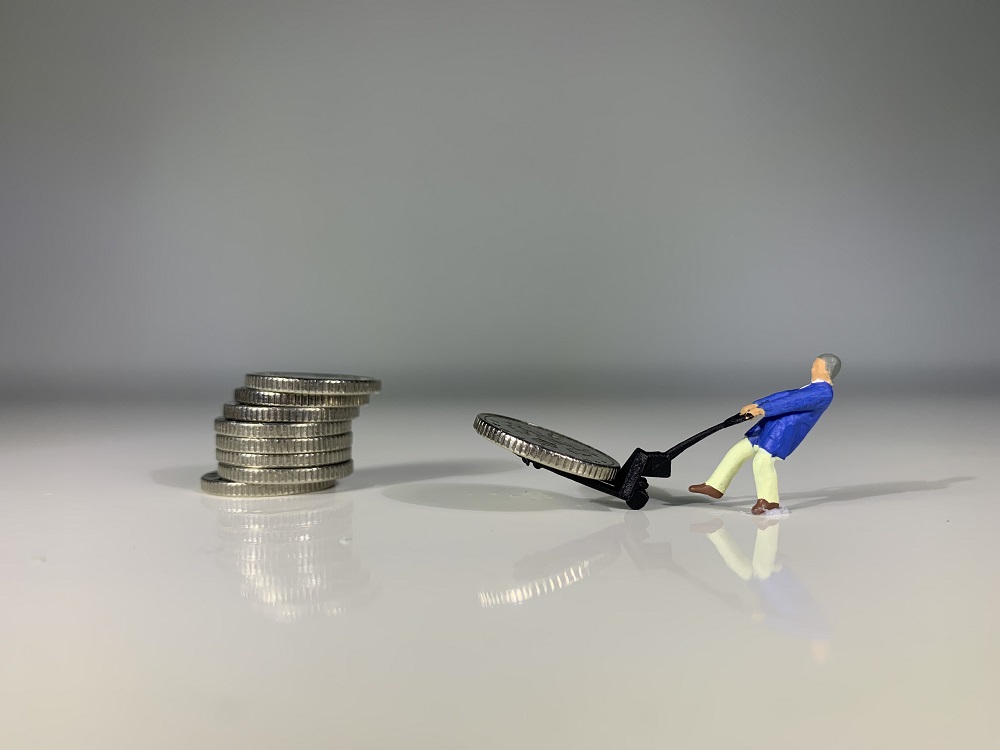 Tiny man moving coins