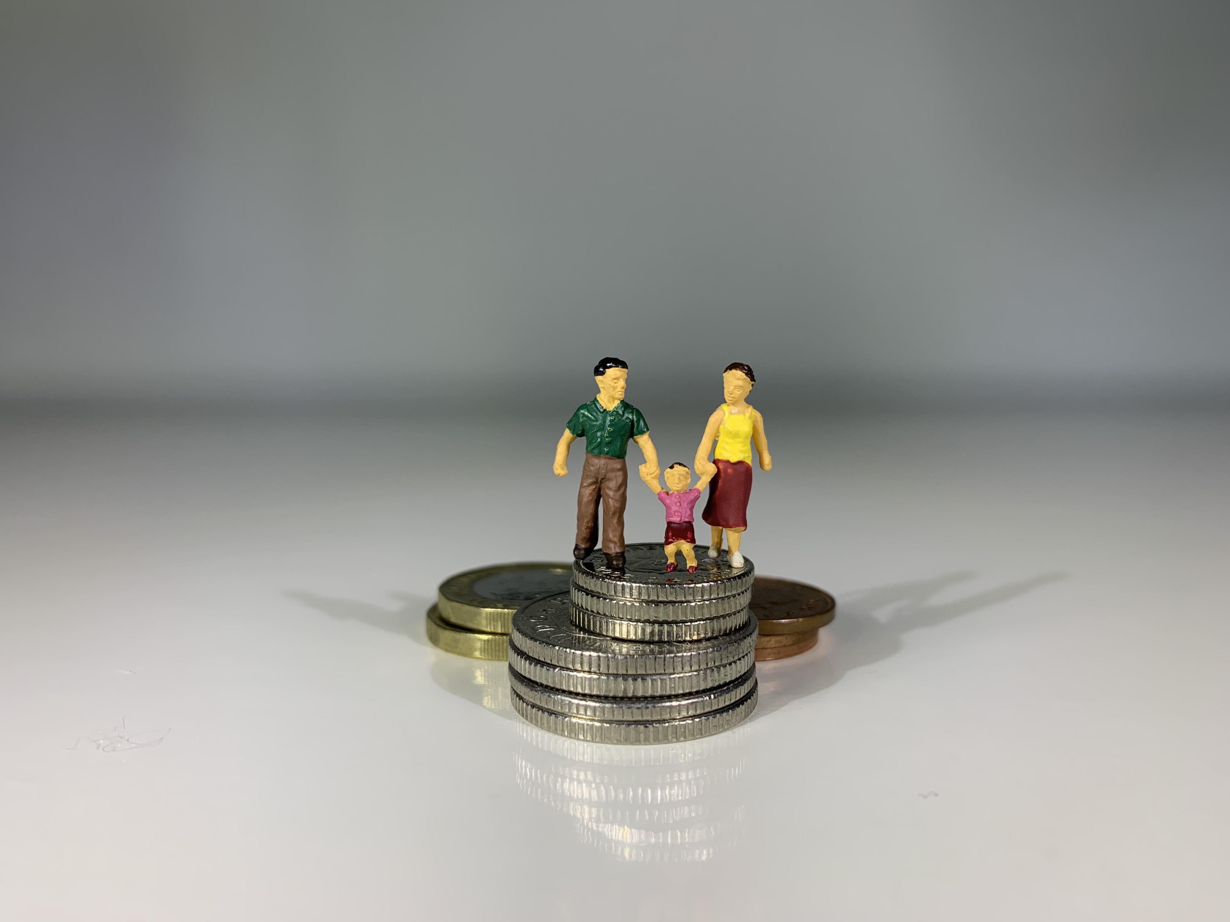 Family standing on coins