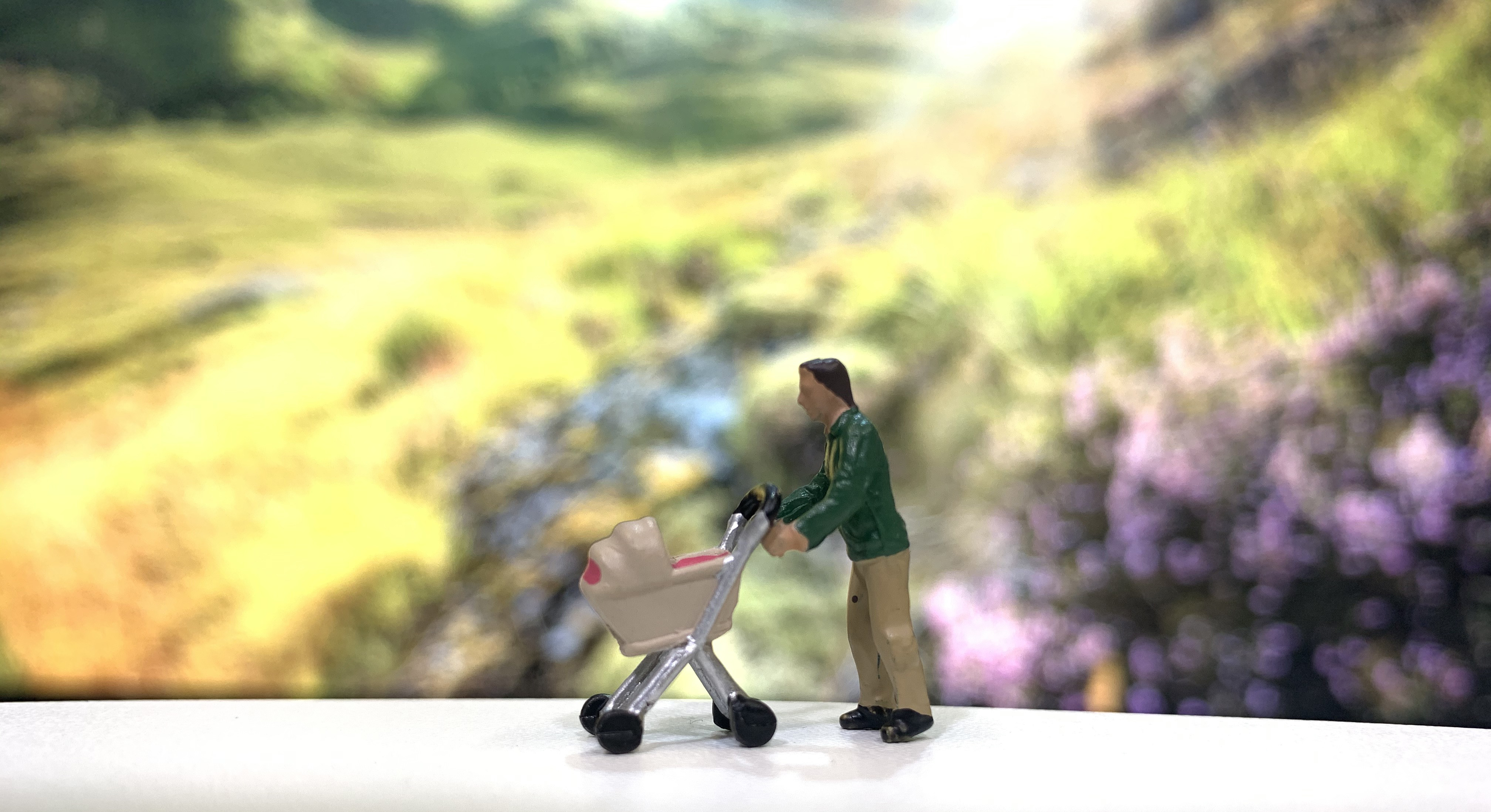 small model figure pushing a pram