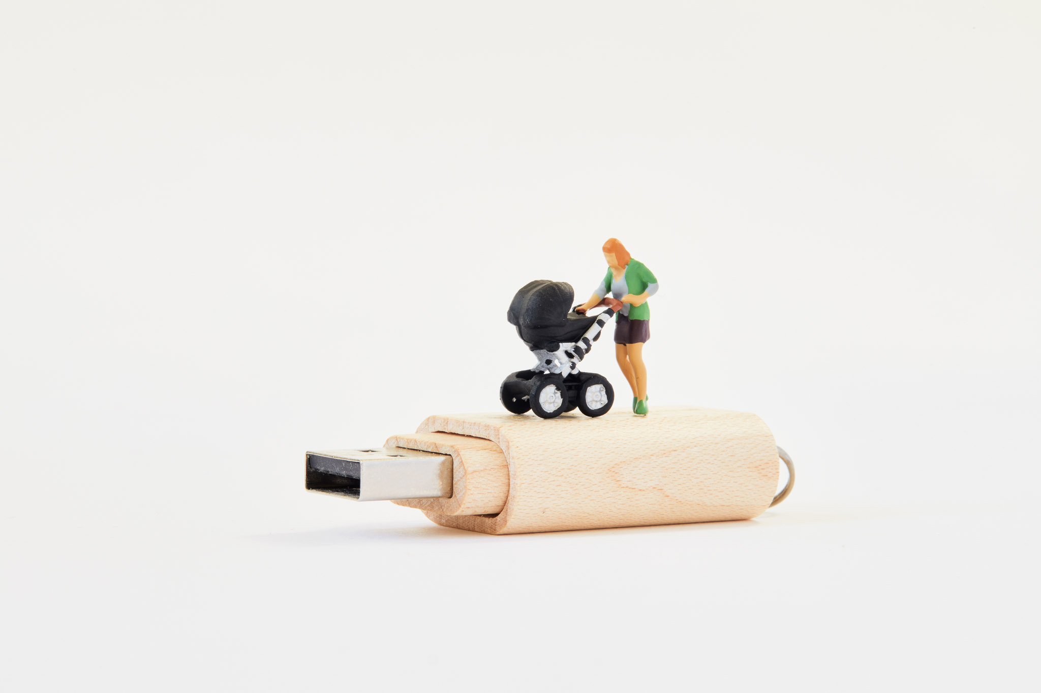 Tiny figure of mother and pram on USB stick