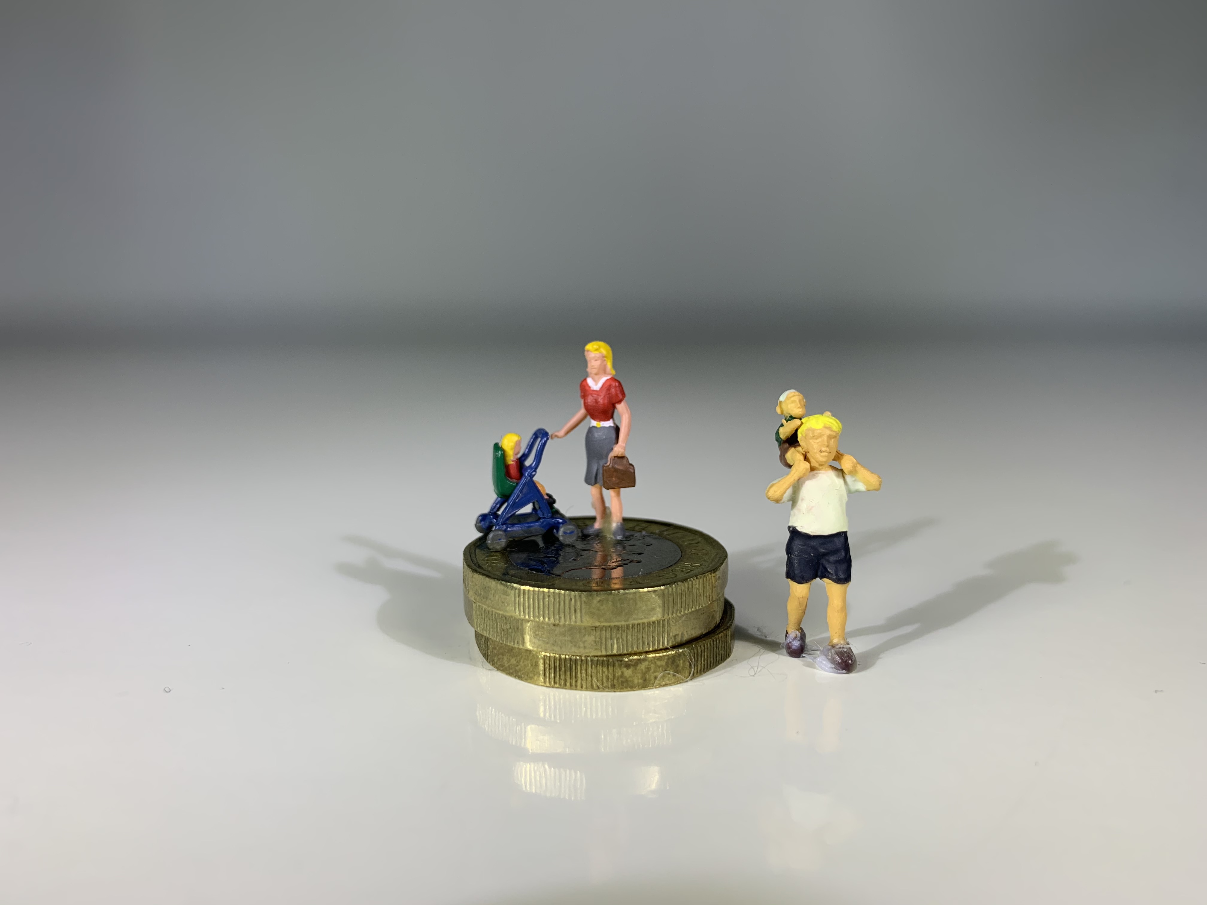 Toy family by coin stack